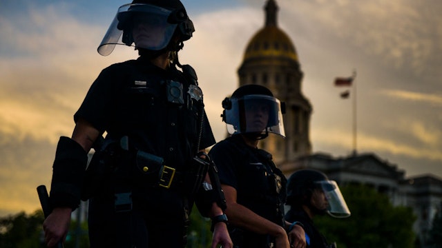 DENVER, CO - MAY 29: Police officers watch over a crowd of people near the Colorado state capitol during a protest on May 29, 2020 in Denver, Colorado. This was the second day of protests in Denver, with more demonstrations planned for the weekend. Demonstrations are being held across the US after George Floyd died in police custody on May 25th in Minneapolis, Minnesota.(Photo by Michael Ciaglo/Getty Images)