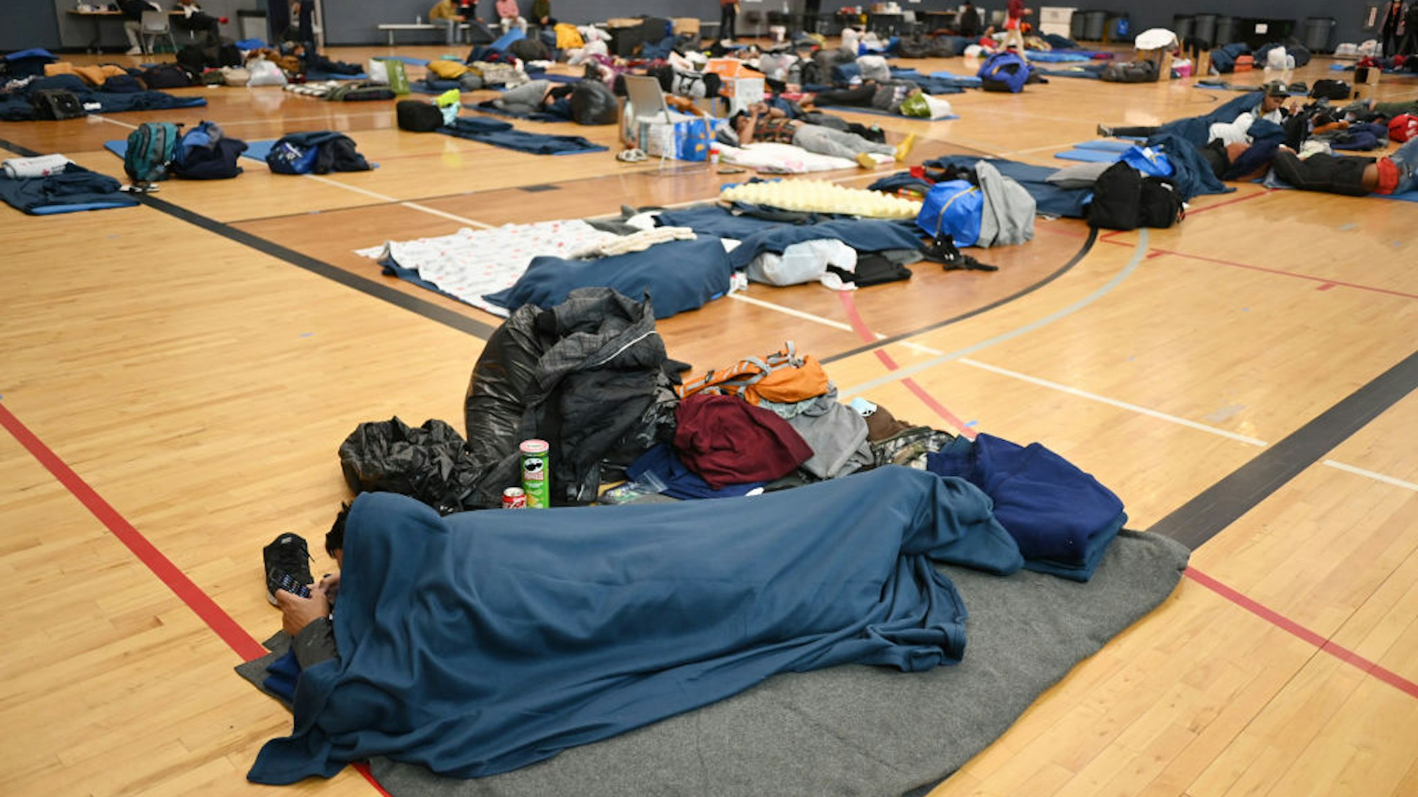DENVER, CO - JANUARY 13 : Migrants share the space at a makeshift shelter in Denver, Colorado on Friday, January 13, 2023. (Photo by Hyoung Chang/The Denver Post)