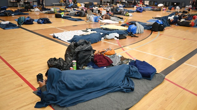 DENVER, CO - JANUARY 13 : Migrants share the space at a makeshift shelter in Denver, Colorado on Friday, January 13, 2023. (Photo by Hyoung Chang/The Denver Post)