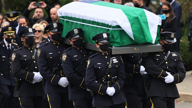 GREENLAWN, NEW YORK - MAY 04: The casket of NYPD Officer Anastasios Tsakos is carried by pallbearers past friends and family during his funeral service at St. Paraskevi Greek Orthodox Shrine Church on May 04, 2021 in Greenlawn, New York. Officer Tsakos was killed in the line of duty by an alleged drunk driver on the Long Island Expressway on April 27.