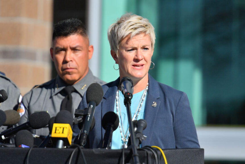 SANTA FE, NEW MEXICO - OCTOBER 27: Santa Fe County Sheriff Adan Mendoza (L) looks on as First Judicial District Attorney Mary Carmack-Altwies for the state of New Mexico speaks during a press conference at the Santa Fe County Public Safety Building to update members of the media on the shooting accident on the set of the movie "Rust" at the on October 27, 2021 in Santa Fe, New Mexico. On October 21, 2021, Director of Photography Halyna Hutchins was killed and director Joel Souza was injured on set while filming the movie "Rust" at Bonanza Creek Ranch near Santa Fe, New Mexico. The film's star and also a producer Alec Baldwin discharged a prop firearm and a bullet hit Hutchins and Souza. (Photo by Sam Wasson/Getty Images)