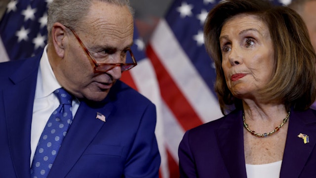 House Speaker Nancy Pelosi (D-CA) speaks with Senate Majority Leader Chuck Schumer (D-NY) during a bill enrollment ceremony for the Respect For Marriage Act at the U.S. Capitol Building on December 08, 2022 in Washington, DC.