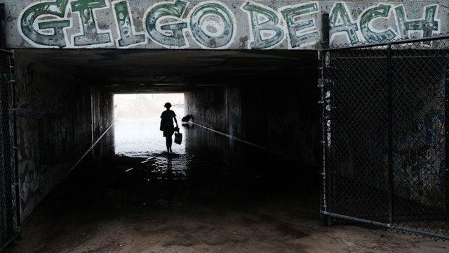 A teenager walks to Gilgo Beach on July 18, 2023 in Babylon, New York.