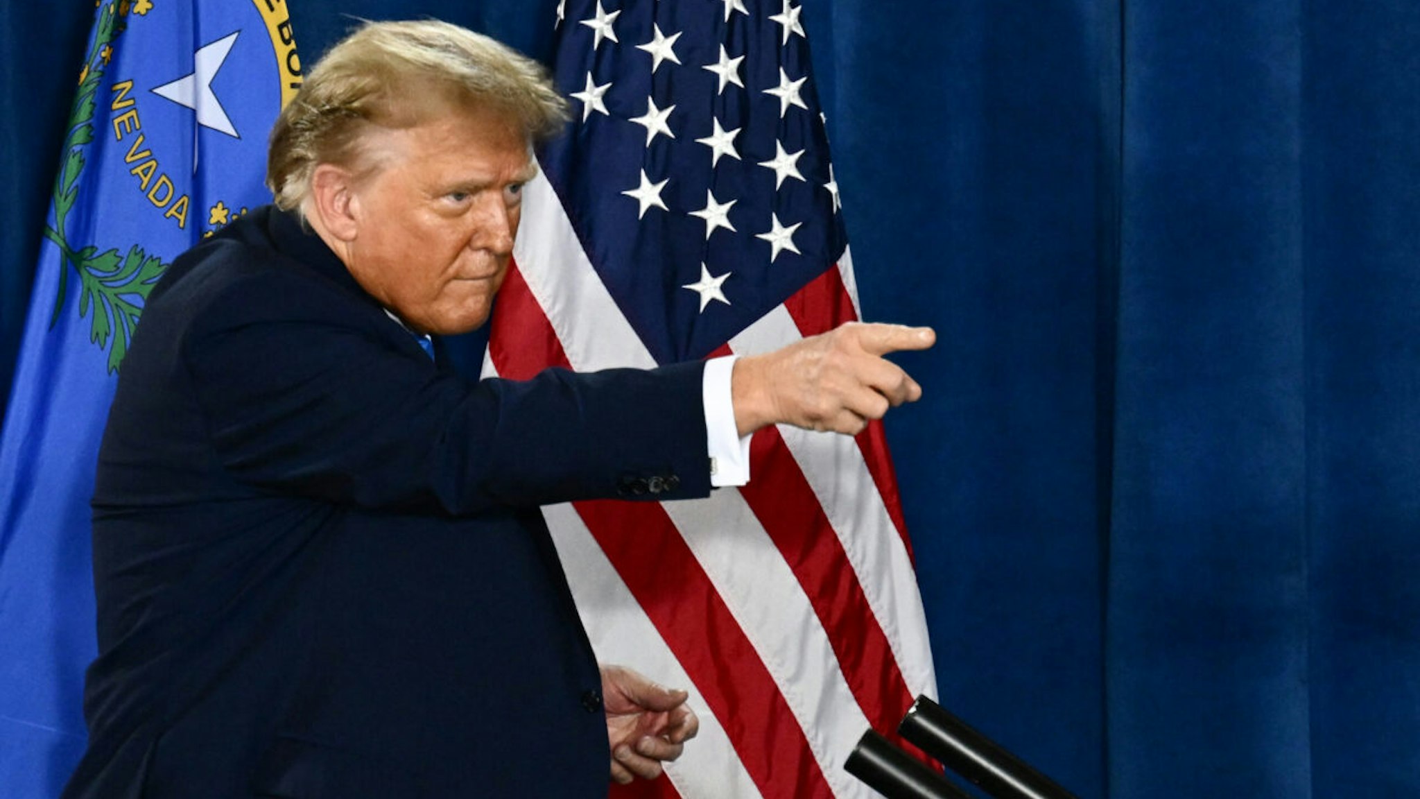 Former US President and 2024 presidential hopeful Donald Trump points after speaking at a Commit to Caucus Rally in Las Vegas, Nevada, on January 27, 2024.