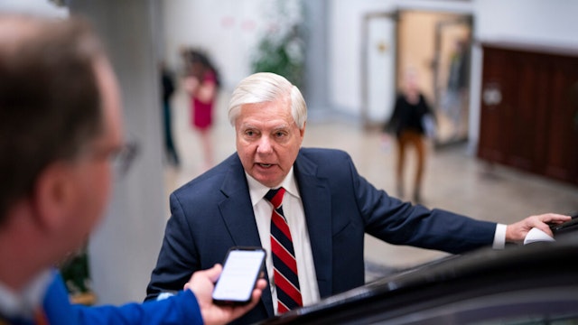 Senator Lindsey Graham, a Republican from South Carolina, speaks with members of the media while arriving in the Senate Subway during a vote at the US Capitol in Washington, DC, US, on Wednesday, Feb. 7, 2024.