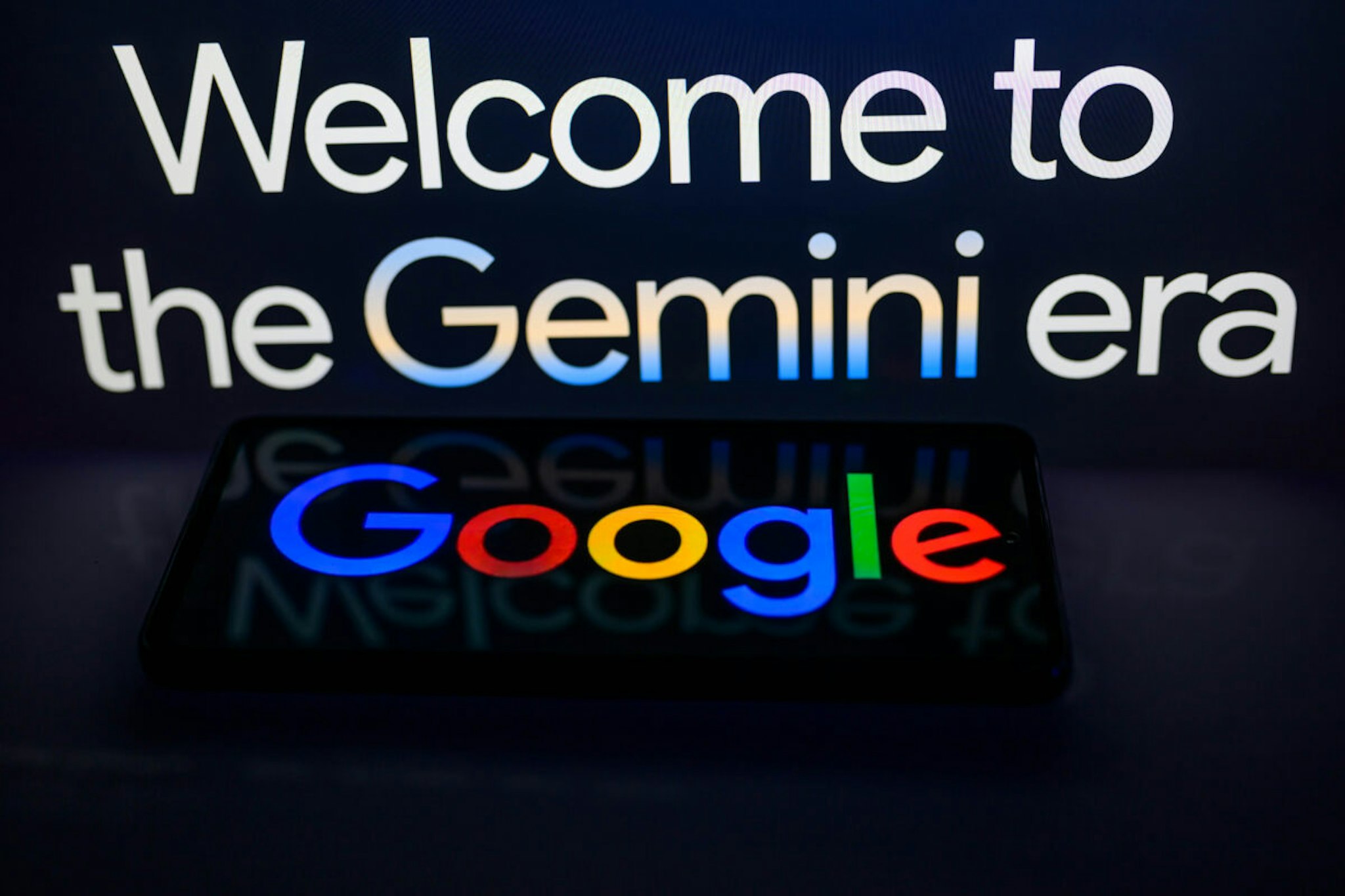 A smart phone displaying Google with the Gemini web page slogan in the background is featured in this photo illustration in Brussels, Belgium, on February 8, 2024.