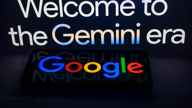 A smart phone displaying Google with the Gemini web page slogan in the background is featured in this photo illustration in Brussels, Belgium, on February 8, 2024.