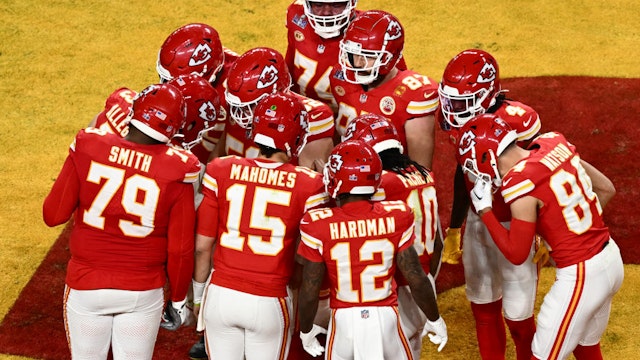 Kansas City Chiefs' players huddle during Super Bowl LVIII between the Kansas City Chiefs and the San Francisco 49ers at Allegiant Stadium in Las Vegas, Nevada, February 11, 2024. (Photo by Patrick T. Fallon / AFP) (Photo by PATRICK T. FALLON/AFP via Getty Images)