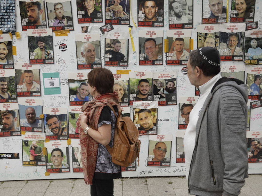 TEL AVIV, ISRAEL - FEBRUARY 12: People view posters of missing Israelis on a wall at Hostages Square on February 12, 2024 in Tel Aviv, Israel. The Israeli military says it has rescued two hostages from captivity in Rafah, whilst two 21-year old IDF soldiers were killed in overnight fighting in the Gaza Strip. The IDF has now rescued three hostages through military operations since Oct. 7, as PM Netanyahu faces pressure from relatives of freed hostages to secure the release of the remaining captives through negations with Hamas. (Photo by Amir Levy/Getty Images)