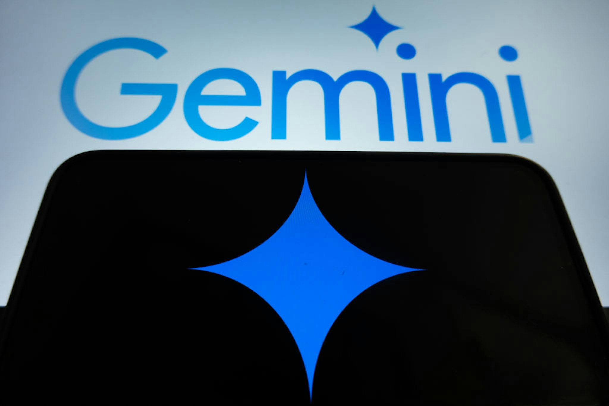 In this photo illustration Gemini logo and an AI icon are displayed on two screens in L'Aquila, Italy, on February 12th, 2024. Google replaced its AI chatbot "Google Bard" with Gemini. (Photo by Lorenzo Di Cola/NurPhoto via Getty Images)