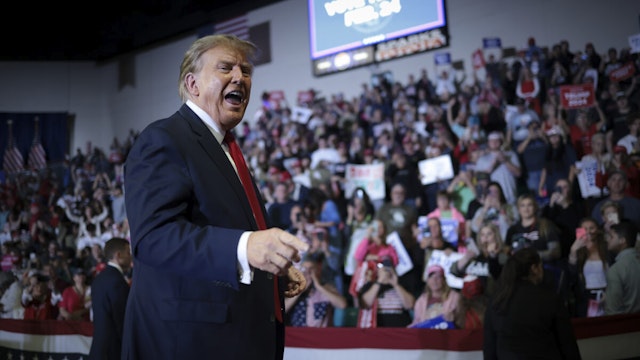 Republican presidential candidate and former President Donald Trump gestures to members of the audience as he leaves a Get Out The Vote rally at Coastal Carolina University on February 10, 2024 in Conway, South Carolina.