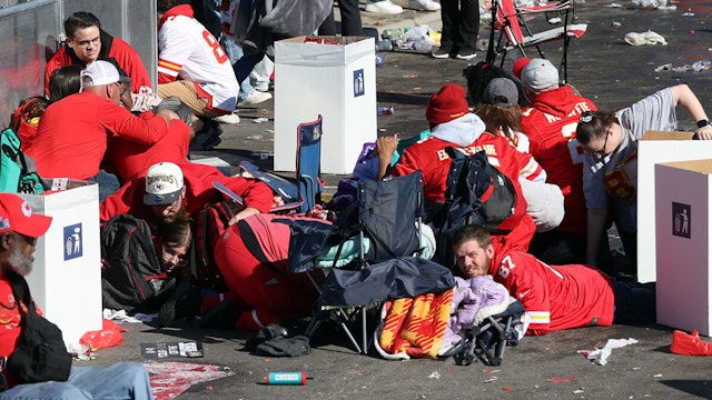 KANSAS CITY, MISSOURI - FEBRUARY 14: People take cover during a shooting at Union Station during the Kansas City Chiefs Super Bowl LVIII victory parade on February 14, 2024 in Kansas City, Missouri. Several people were shot and two people were detained after a rally celebrating the Chiefs Super Bowl victory.