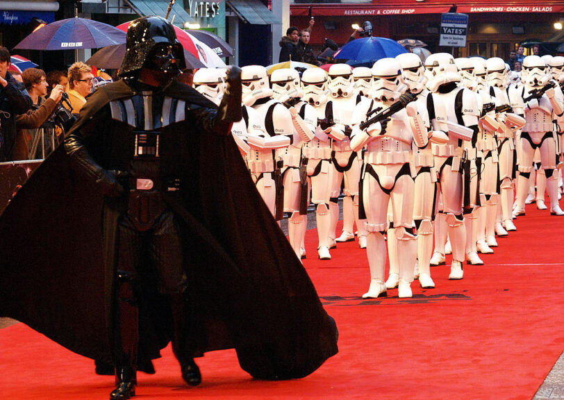 LONDON, UNITED KINGDOM: Darth Vader waves his fist at the crowd, as he leads the Star Wars Troopers into the London Premiere of Star Wars Episode III, Revenge of the Sith. AFP PHOTO/Max Nash (Photo credit should read MAX NASH/AFP via Getty Images)