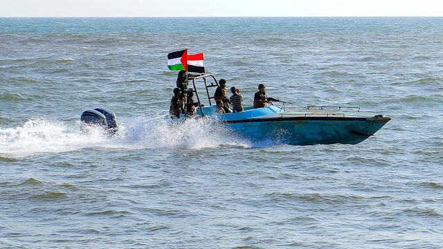 TOPSHOT - Members of the Yemeni Coast Guard affiliated with the Houthi group patrol the sea as demonstrators march through the Red Sea port city of Hodeida in solidarity with the people of Gaza on January 4, 2024, amid the ongoing battles between Israel and the militant Hamas group in Gaza.
