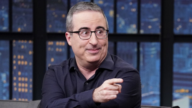 LATE NIGHT WITH SETH MEYERS -- Episode 1405 -- Pictured: (l-r) Comedian John Oliver during an interview with host Seth Meyers on March 13, 2023