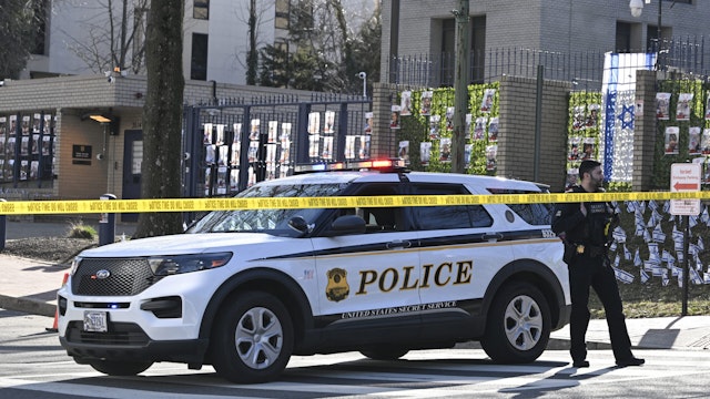 WASHINGTON D.C., UNITED STATES - FEBRUARY 25: Police take security measures and investigate the crime scene after 25-year-old Aaron Bushnell, an active-duty member of the US Air Force, set himself on fire Sunday outside the Israeli Embassy in Washington, D.C. in protest against the war in Gaza on February 25, 2024.