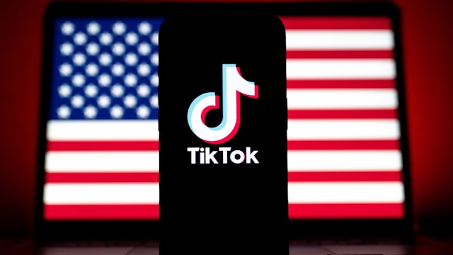 In this photo illustration logo of TikTok and U.S. flag are displayed in Ankara, Turkiye on March 12, 2024.