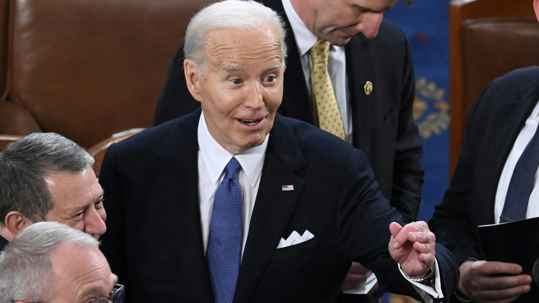 US President Joe Biden mingles with lawmakers as he departs at the conclusion of his State of the Union address in the House Chamber of the US Capitol in Washington, DC, on March 7, 2024.