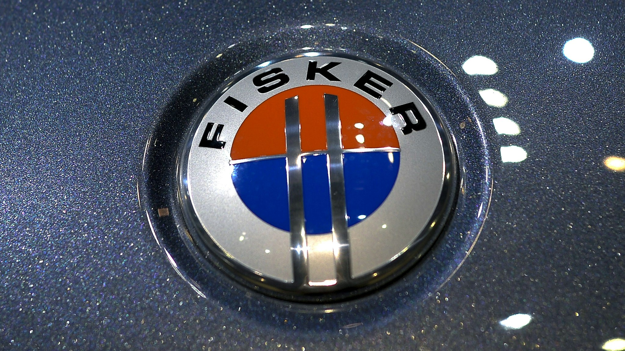 The emblem of a Fisker Karma electric car is seen at the US car maker's booth during the 83rd Geneva Motor Show on March 6, 2013. The European crisis hovered like a dark cloud over the Geneva International Motor Show, but there was no lack of new luxury cars shining on the showroom floor. McLaren, Ferrari and Lamborghini all unveiled so-called supercars to be sold for between one to three million euros ($1.3 - $3.9 million). AFP PHOTO / FABRICE COFFRINI