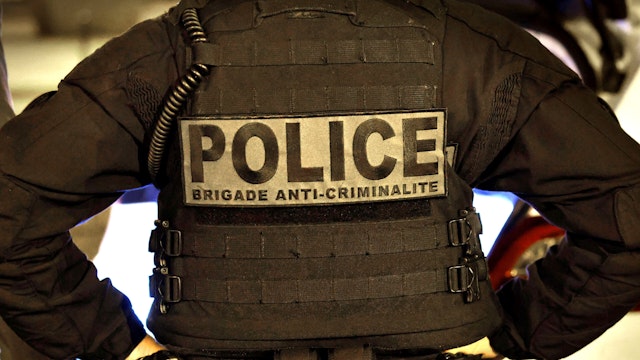 A French police officer of the anti-crime squad, Brigade Anti-Criminalite de nuit (BAC N 75) is seen during a night patrol in Paris on October 16, 2020.