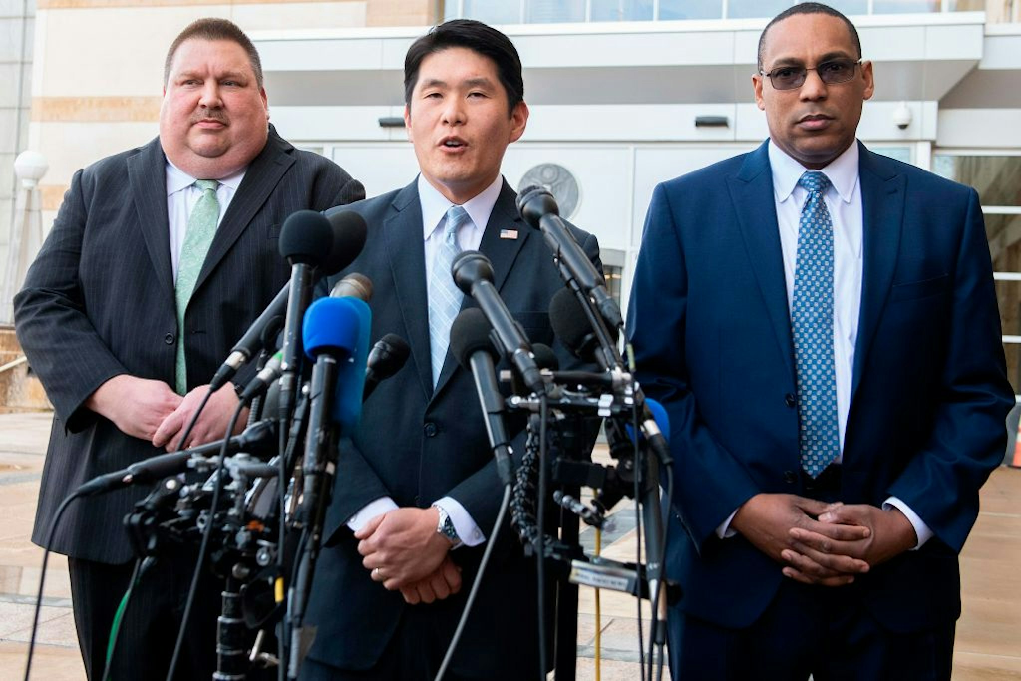 US Attorney for Maryland Robert Hur (C) speaks with FBI Special Agent In Charge of the Baltimore Field Office Gordon Johnson (R) and US Coast Guard Investigator Art Walker (L) outside the US Court House in Greenbelt, MD, on February 21, 2019, after US Coast Guard Lt. Christopher Hasson, 49, of Silver Spring, Maryland, was arrested last week on illegal weapons and drug charges as a result of an ongoing investigation led by the Coast Guard Investigative Service, in cooperation with the FBI and Department of Justice. (Photo by Jim WATSON / AFP)