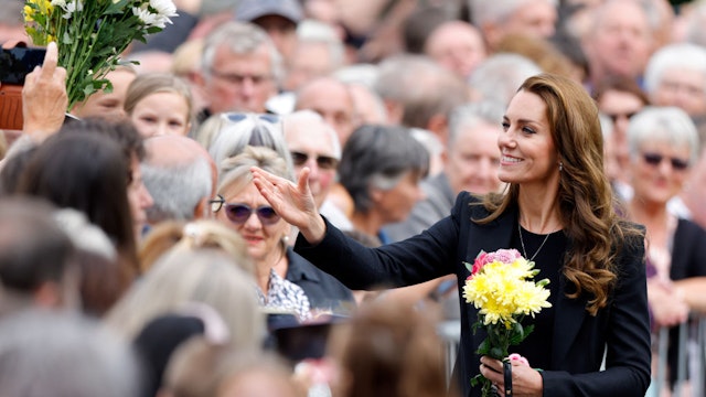 SANDRINGHAM, NORFOLK - SEPTEMBER 15: (EMBARGOED FOR PUBLICATION IN UK NEWSPAPERS UNTIL 24 HOURS AFTER CREATE DATE AND TIME) Catherine, Princess of Wales receives bouquets of flowers as she meets members of the public after viewing floral tributes left at the entrance to Sandringham House, the Norfolk estate of Queen Elizabeth II, on September 15, 2022 in Sandringham, England. The Prince and Princess of Wales are visiting Sandringham to view tributes to Queen Elizabeth II, who died at Balmoral Castle on September 8, 2022. (Photo by Max Mumby/Indigo/Getty Images)
