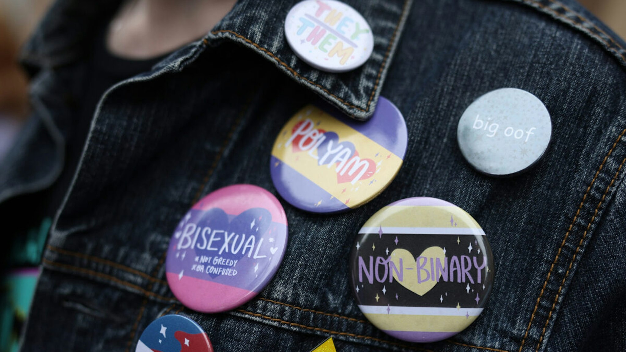 Bisexual and non-binary badges are seen on a protester outside The Oxford Union on May 30, 2023 in Oxford, England.