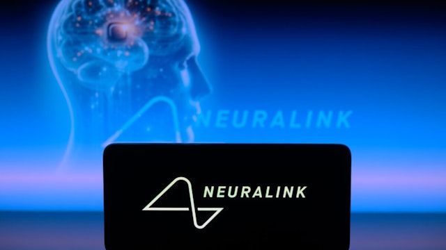 The Neuralink logo is displayed on a smartphone with Neuralink visible in the background in this photo illustration in Brussels, Belgium, on January 30, 2024.
