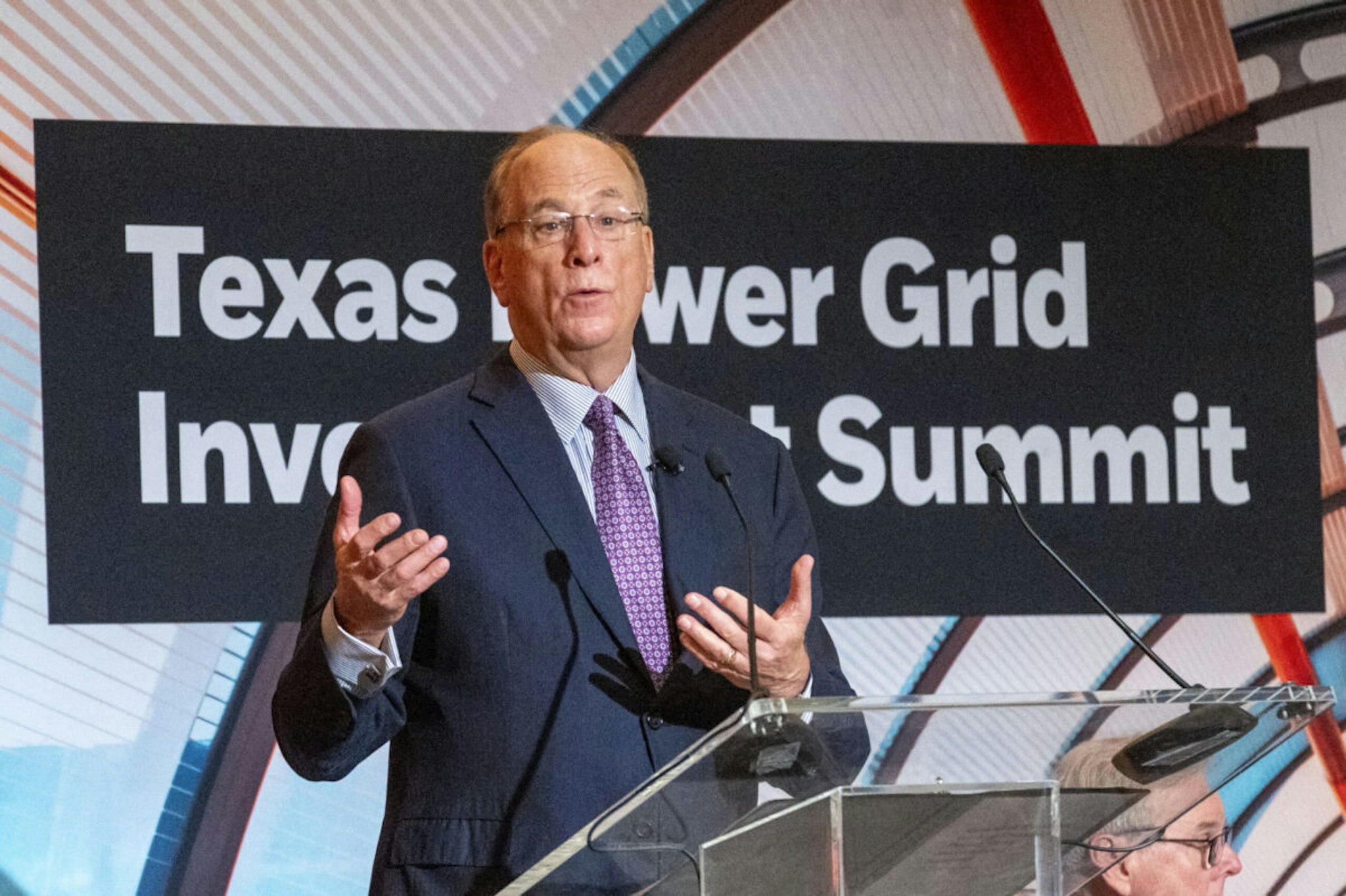 Lieutenant Governor Dan Patrick, right, listens as Larry Fink, Chairman and Chief Executive Officer of BlackRock, makes a statement during opening remarks of the Texas Power Grid Investment Summit, Tuesday, Feb. 6, 2024 in Houston.