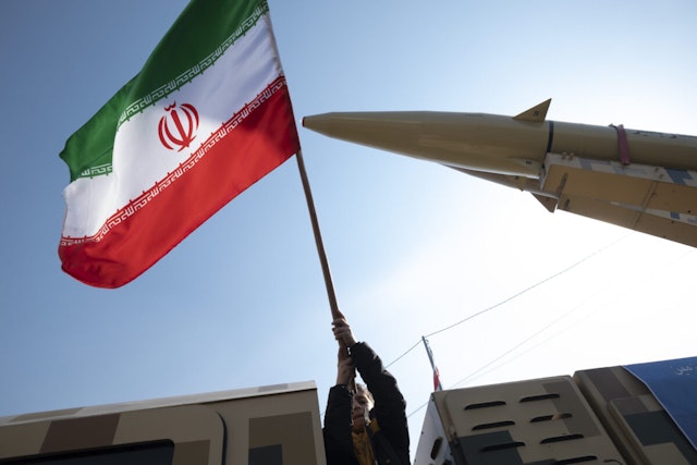 A young boy is waving an Iranian flag next to the Iranian-made Zolfaghar missile on display at Azadi (Freedom) Square in western Tehran, Iran, on February 11, 2024, during a rally to mark the 45th anniversary of the victory of Iran's 1979 Islamic Revolution. The Iranian Islamic Revolution, which led to the overthrow of the Pahlavi dynasty in 1979, replaced the Imperial State of Iran with the present-day Islamic Republic of Iran.