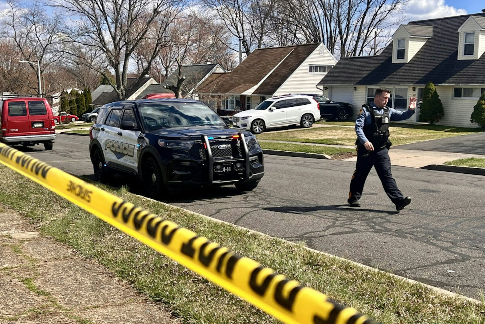 A police officer patrols a neighborhood during an active shooter situation in Levittown, a community within Falls Township, Pennsylvania, where a a shelter-in-place order was issued on March 16, 2024. Three people were killed by gunfire in a Philadelphia suburb on Saturday morning and the suspect was on the loose following a carjacking, local media and the police reported. Police in Middletown Township, just north of Philadelphia, confirmed on their Facebook page that shots had been fired in nearby Falls Township, leaving "several gunshot victims."