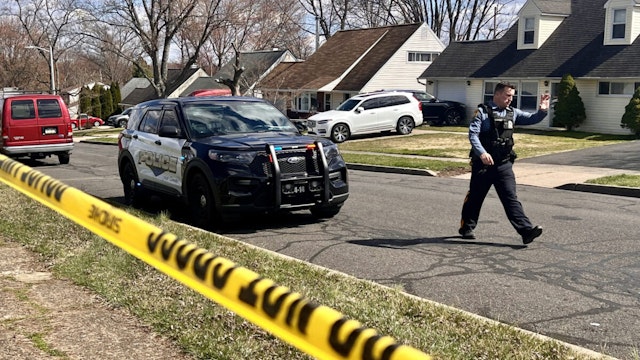 A police officer patrols a neighborhood during an active shooter situation in Levittown, a community within Falls Township, Pennsylvania, where a a shelter-in-place order was issued on March 16, 2024. Three people were killed by gunfire in a Philadelphia suburb on Saturday morning and the suspect was on the loose following a carjacking, local media and the police reported. Police in Middletown Township, just north of Philadelphia, confirmed on their Facebook page that shots had been fired in nearby Falls Township, leaving "several gunshot victims."