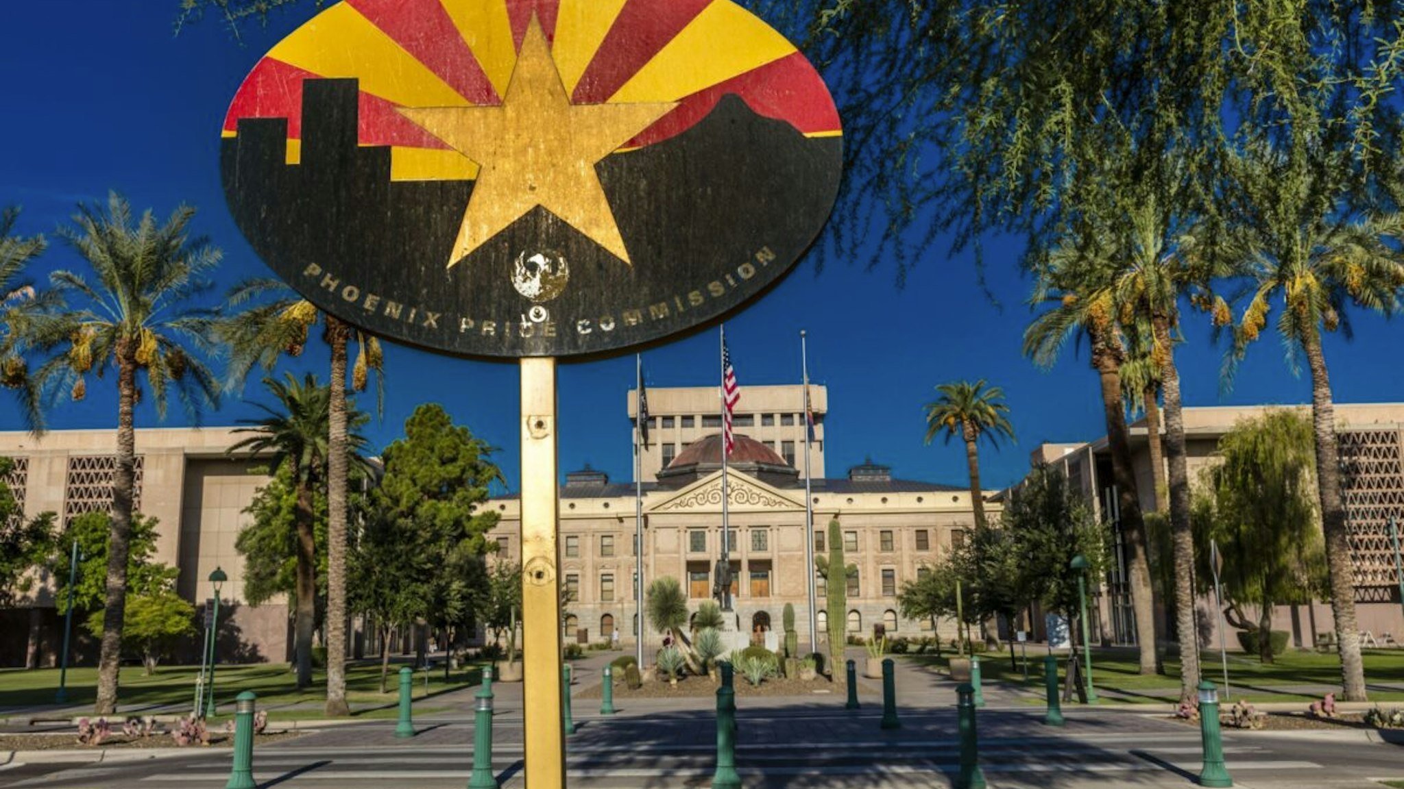 Arizona State Capitol Building at sunrise, Phoenix, Arizona shows 'Arizona State Flag'.