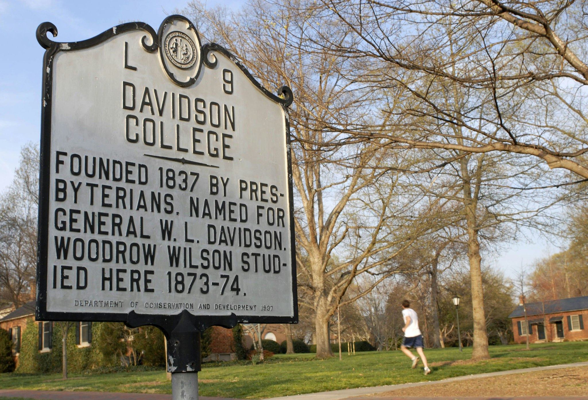 A runner passes a sign on the campus of Davidson College in Davidson, North Carolina, Monday, March 19, 2007.