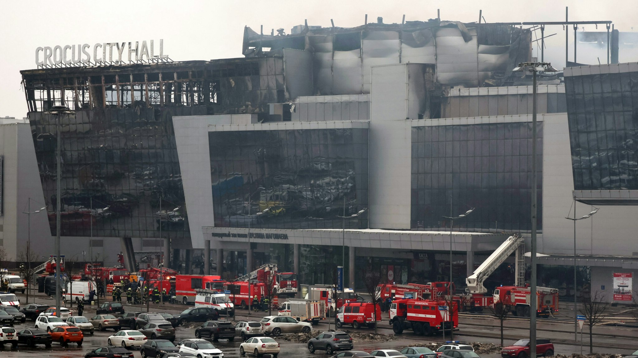 TOPSHOT - Members of emergency services work at the scene of the gun attack at the Crocus City Hall concert hall in Krasnogorsk, outside Moscow, on March 23, 2024. Gunmen who opened fire at a Moscow concert hall killed more than 60 people and wounded over 100 while sparking an inferno, authorities said on March 23, 2024, with the Islamic State group claiming responsibility.