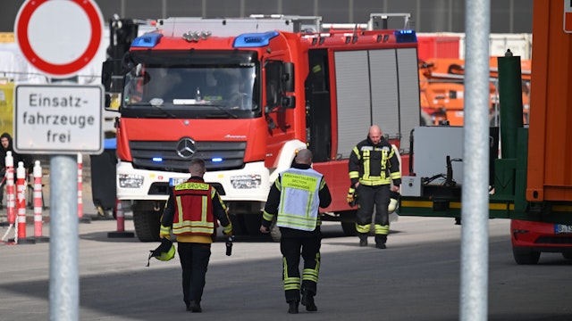 05 March 2024, Brandenburg, Grünheide: Fire department and plant fire department vehicles are parked on the site of the Tesla car factory in Grünheide, where production has come to a standstill due to a power outage. The factory in Grünheide near Berlin has been evacuated, a spokeswoman said.