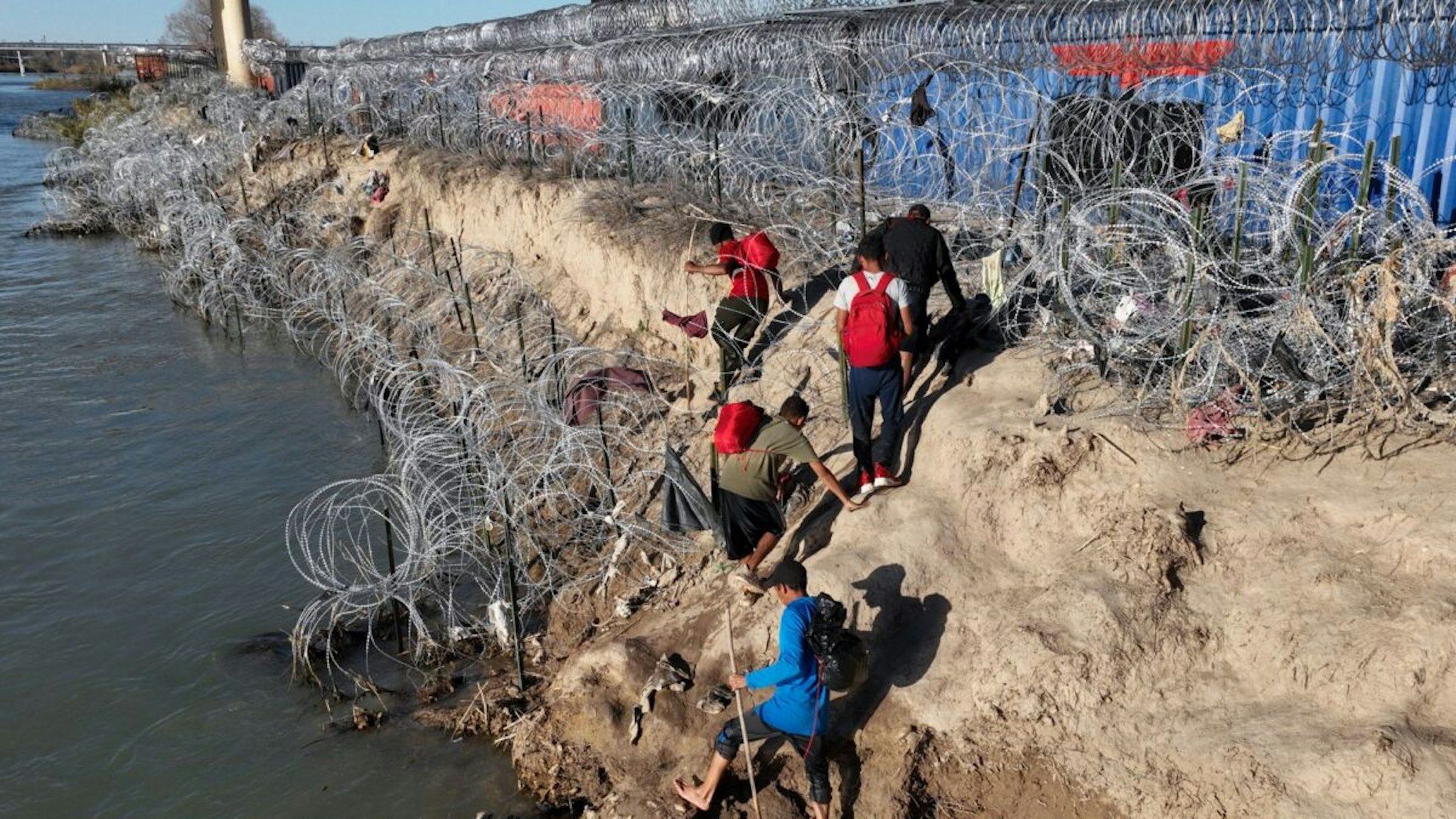 EAGLE PASS, TEXAS - FEBRUARY 03: An aerial view shows an immigrant group trying to cross the Texan border despite heightened security measures in Eagle Pass, Texas on February 03, 2024.