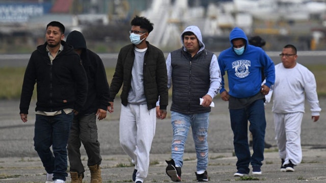 Guatemalan migrants deported from the United States walk on the airport runway upon their arrival at the Air Force Base in Guatemala City on May 11, 2023, during the last flight of returnees from the United States under Title 42.
