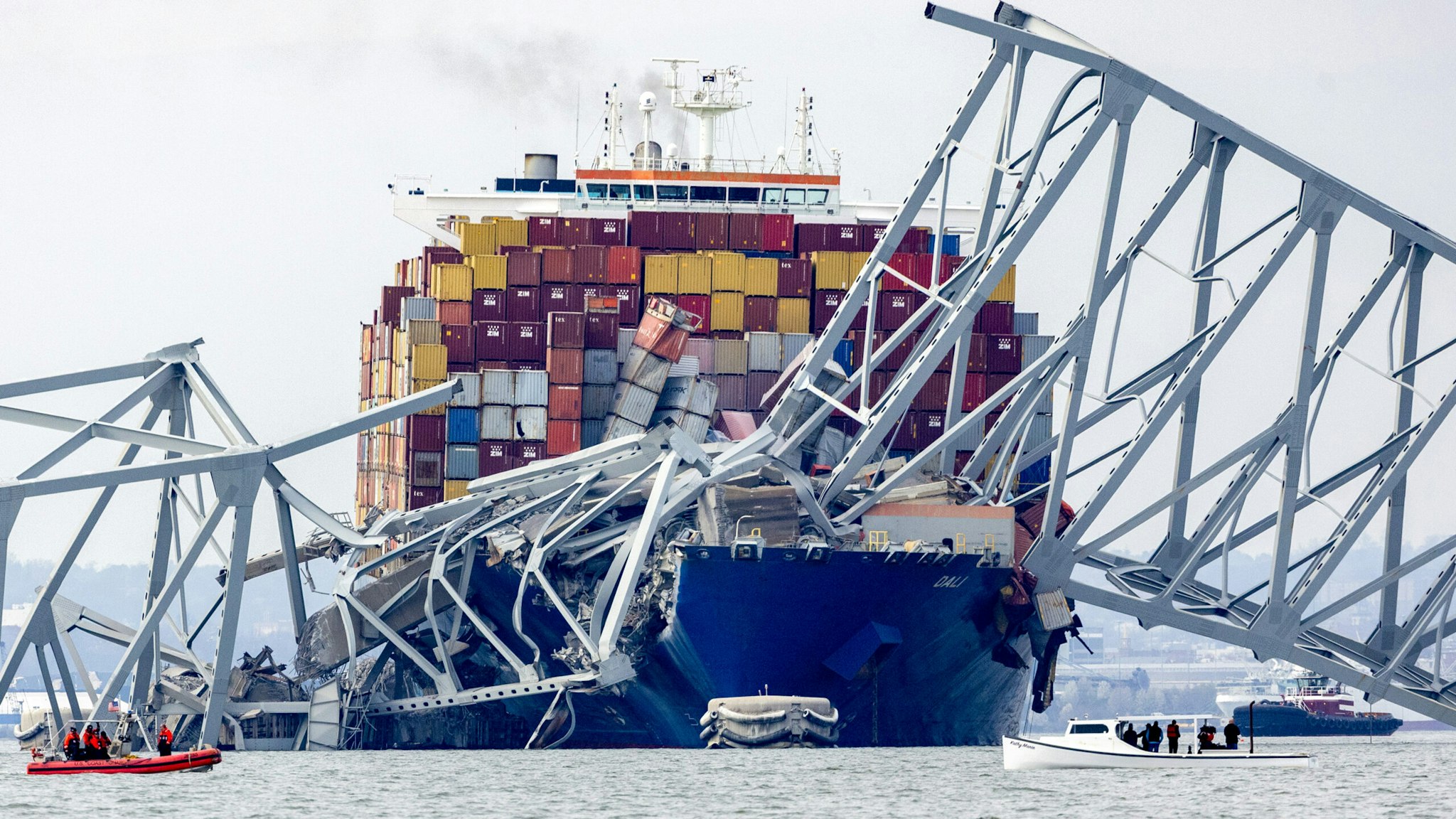 BALTIMORE, MARYLAND - MARCH 26: The cargo ship Dali sits in the water after running into and collapsing the Francis Scott Key Bridge on March 26, 2024 in Baltimore, Maryland. According to reports, rescuers are still searching for multiple people, while two survivors have been pulled from the Patapsco River. A work crew was fixing potholes on the bridge, which is used by roughly 30,000 people each day, when the ship struck at around 1:30am on Tuesday morning. The accident has temporarily closed the Port of Baltimore, one of the largest and busiest on the East Coast of the U.S.