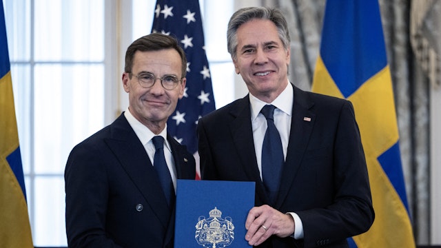 TOPSHOT - US Secretary of State Antony Blinken receives the NATO ratification documents from Swedish Prime Minister Ulf Kristersson during a ceremony at the US State Department, as Sweden formally joins the North Atlantic alliance, in Washington, DC, on March 7, 2024. Kristersson hailed his country's entry into NATO as a "victory for freedom," as it turned the page on two centuries of non-alignment following Russia's invasion of Ukraine. The accession "is a victory for freedom today. Sweden has made a free, democratic, sovereign and united choice to join NATO," he said at the ceremony.