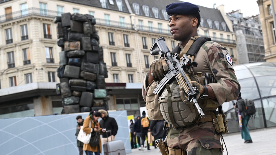A French soldier of the Sentinelle security operation patrols in front of the Saint-Lazare railway station in Paris on March 25, 2024. Four months ahead of the Paris 2024 Olympic Games, French authorities has raised the maximum alert level for terrorist threat, after the Moscow attack carried out, according to the French President, by an "entity" of the "Islamic State" group behind "several recent attempts" on French territory.