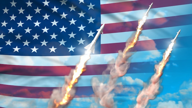 USA nuclear warhead launch - modern strategic nuclear rocket weapons concept on blue sky background, military industrial 3D illustration with flag