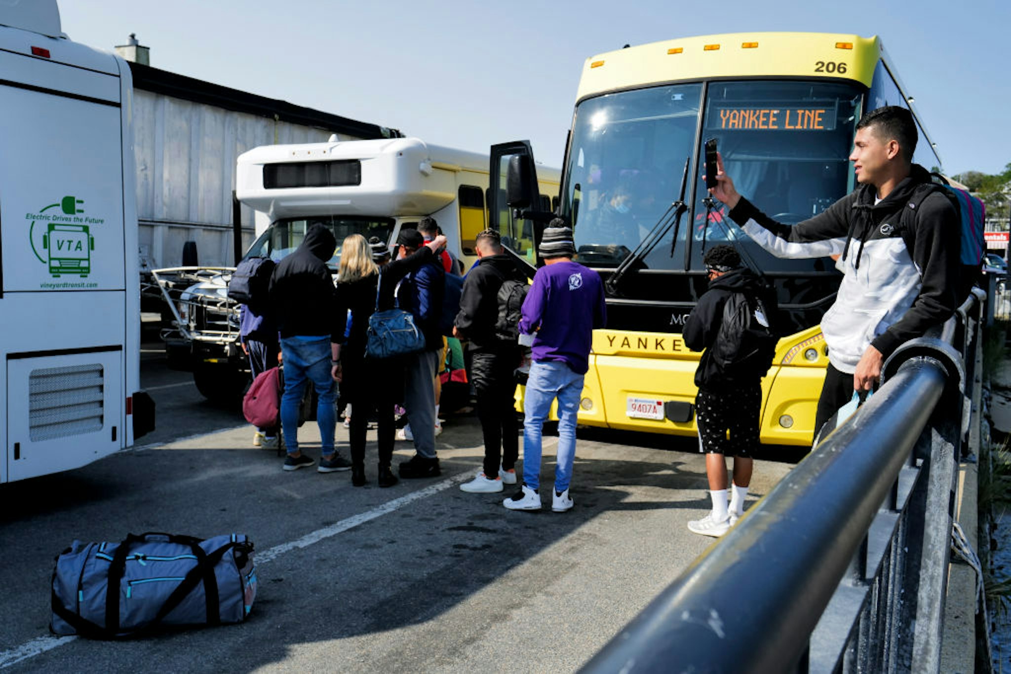 Martha's Vineyard, MA - September 16: Venezuelan migrants gather at the Vineyard Haven ferry terminal in Marthas Vineyard. The group was transported to Joint Base Cape Cod in Buzzards Bay. (Photo by Carlin Stiehl for The Boston Globe via Getty Images)