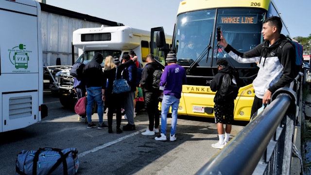 Martha's Vineyard, MA - September 16: Venezuelan migrants gather at the Vineyard Haven ferry terminal in Marthas Vineyard. The group was transported to Joint Base Cape Cod in Buzzards Bay. (Photo by Carlin Stiehl for The Boston Globe via Getty Images)