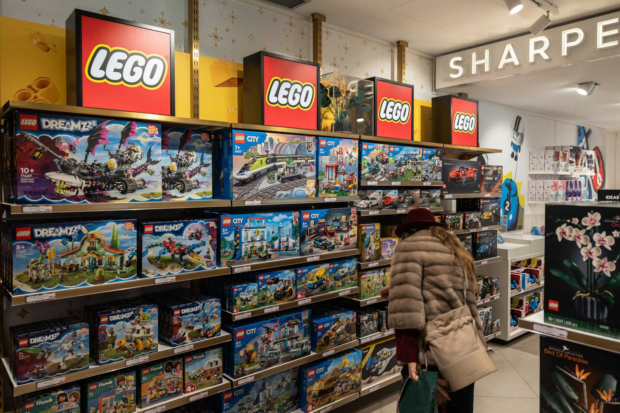 A woman looks at some LEGO sets as she visits the American toy brand Fao Schwarz flagship store on December 05, 2023 in Milan, Italy.
