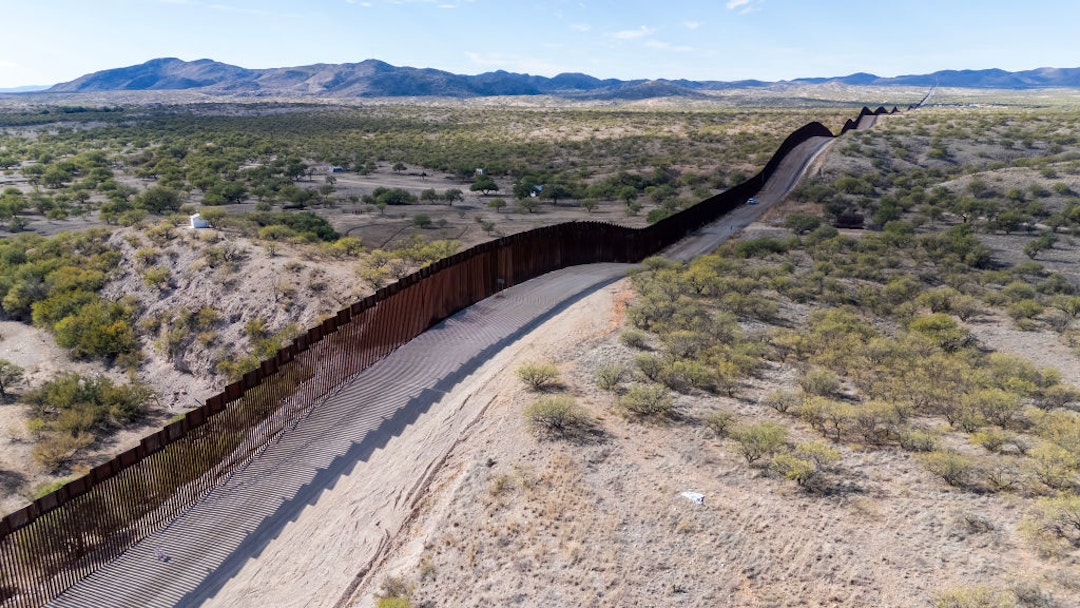 TOPSHOT - This aerial picture taken on December 8, 2023 shows the US-Mexico border wall in Sasabe, Arizona. Jaguars don't understand borders, but where the United States meets Mexico, they are having to adapt to them. Once the master of the plains of the Sonoran Desert, the animal is now struggling to survive in a landscape cut in two by a wall The barrier, which former US President Donald Trump boasted he would make "impenetrable" does little to discourage the thousands of people from Latin America, Asia, Africa and Eastern Europe who arrive every day. But, say conservationists, it is deadly to wildlife. (Photo by VALERIE MACON / AFP)