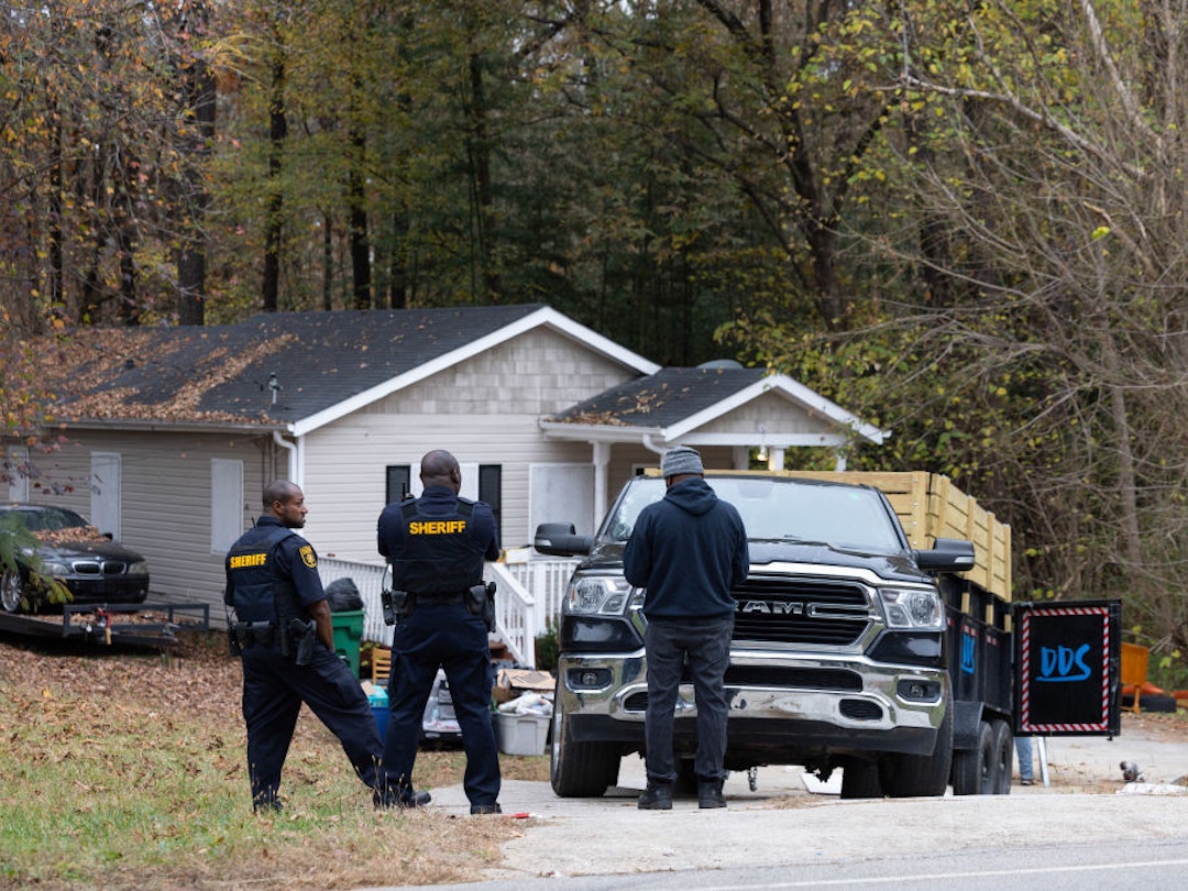 Police supervise the removal of items that belong to squatters from the premises of a rental property in Ellenwood, Georgia, US, on Friday, Nov. 17, 2023. An estimated 1,200 homes are illegally occupied in the Atlanta metro area, an epicenter for institutional investors. Photographer:
