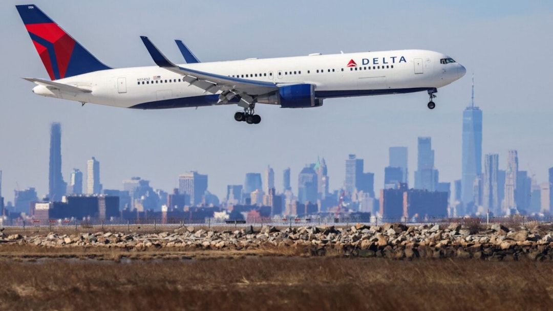 A Boeing 767 passenger aircraft of Delta airlines arrives from Dublin at JFK International Airport in New York as the Manhattan skyline looms in the background on February 7, 2024.