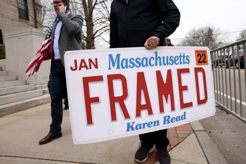 Dedham, MA - March 20: A Karen Read supporter held a sign outside of Norfolk Superior Court following a motions hearing which Read appeared for. Read is accused of murder in the death of her boyfriend, Boston Police Officer John O'Keefe, in a case that's become a media sensation. (Photo by Jessica Rinaldi/The Boston Globe via Getty Images)