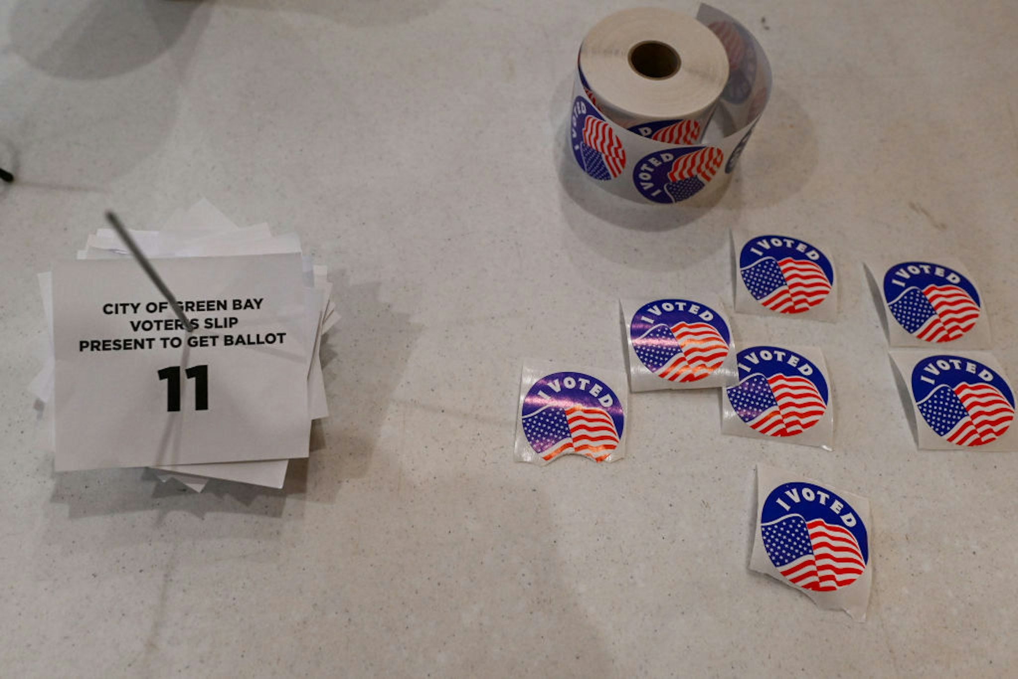 GREEN BAY, WI - APRIL 2: Voting stickers are displayed on a table at polling station at St. Joseph Catholic Church &amp; School on Tuesday, April 2, 2024 in Green Bay, Wisconsin. Republican presidential candidate and former President Donald Trump and Democratic President Joe Biden are the front runners for president in the upcoming 2024 November general election.
